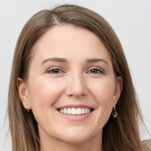 Joyful white young-adult female with long  brown hair and grey eyes