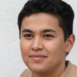 Joyful latino young-adult male with short  brown hair and brown eyes
