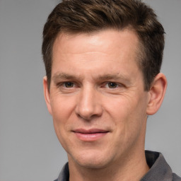 Joyful white adult male with short  brown hair and grey eyes