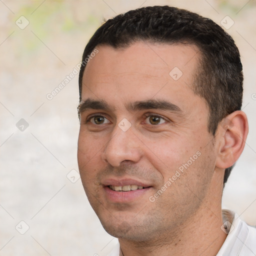 Joyful white adult male with short  black hair and brown eyes