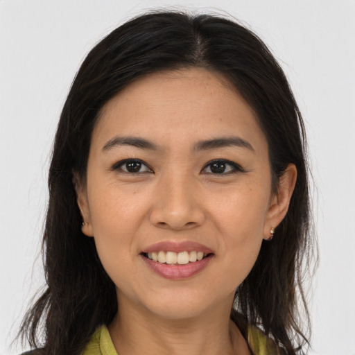 Joyful white young-adult female with long  brown hair and brown eyes