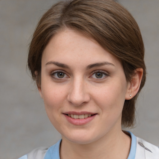 Joyful white young-adult female with medium  brown hair and grey eyes