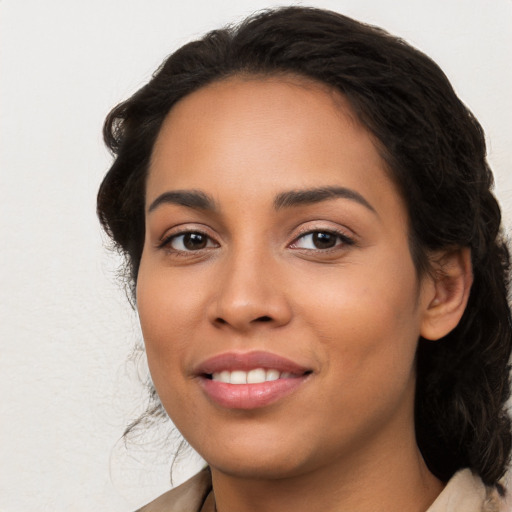 Joyful latino young-adult female with medium  brown hair and brown eyes