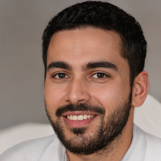 Joyful white young-adult male with short  black hair and brown eyes