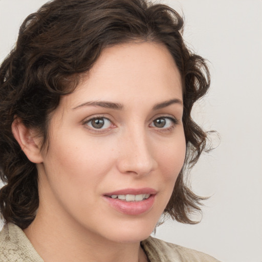 Joyful white young-adult female with medium  brown hair and green eyes