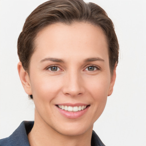 Joyful white young-adult female with short  brown hair and grey eyes