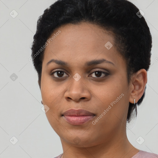 Joyful black young-adult female with short  black hair and brown eyes