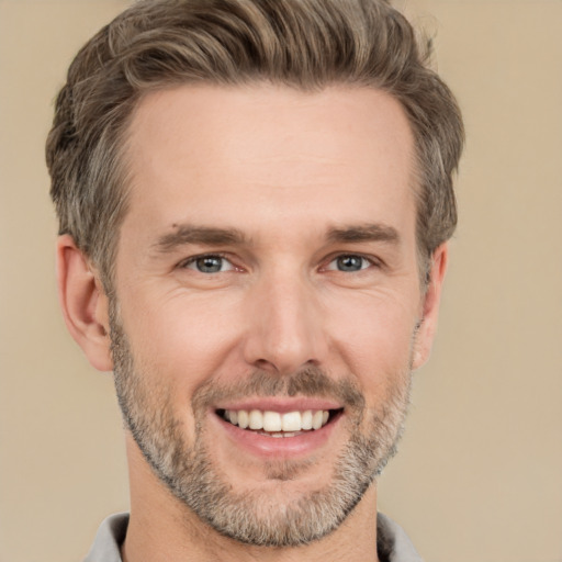 Joyful white adult male with short  brown hair and grey eyes