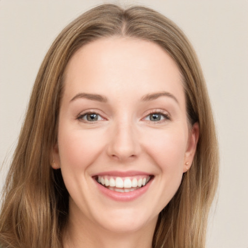 Joyful white young-adult female with long  brown hair and grey eyes