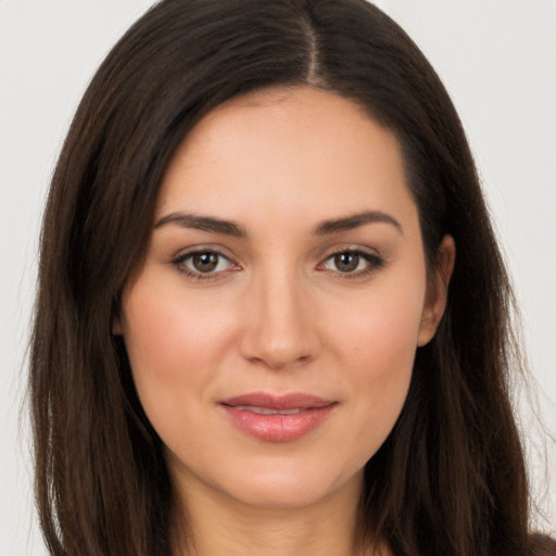 Joyful white young-adult female with long  brown hair and brown eyes