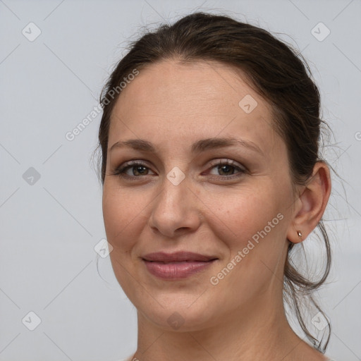 Joyful white adult female with medium  brown hair and grey eyes