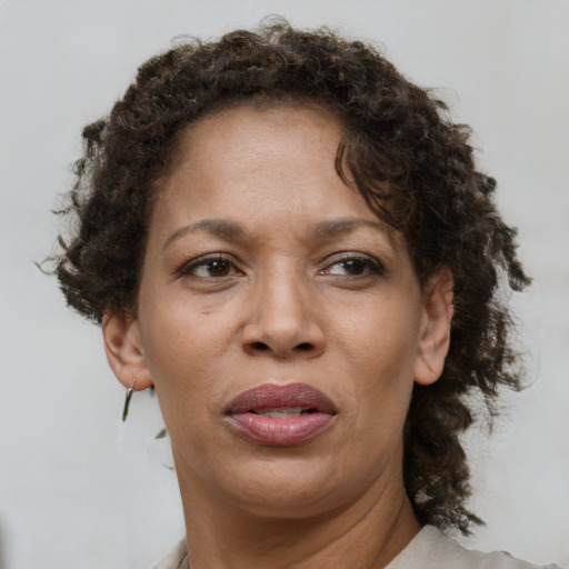 Joyful black adult female with short  brown hair and brown eyes