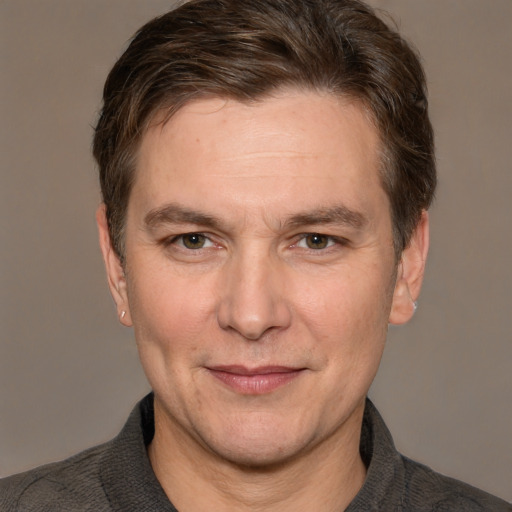 Joyful white adult male with short  brown hair and grey eyes