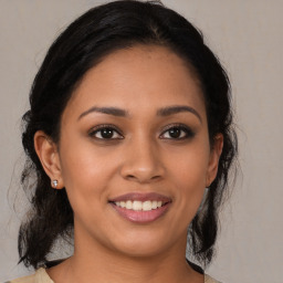 Joyful latino young-adult female with medium  brown hair and brown eyes