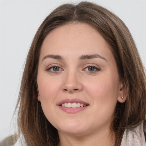 Joyful white young-adult female with long  brown hair and grey eyes