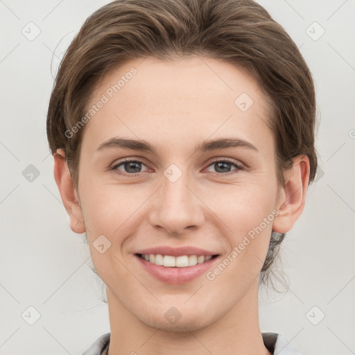 Joyful white young-adult female with short  brown hair and grey eyes