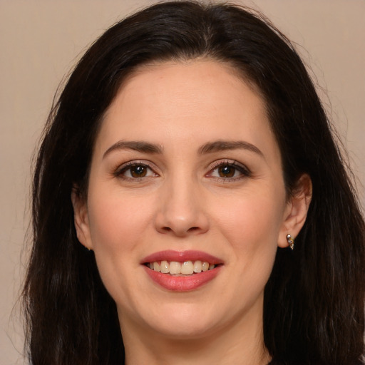 Joyful white young-adult female with long  brown hair and brown eyes