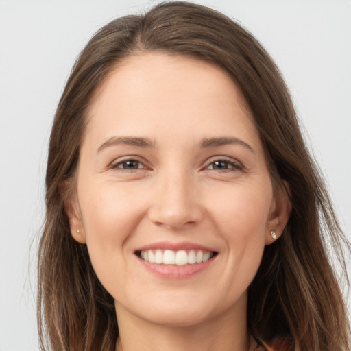 Joyful white young-adult female with long  brown hair and brown eyes