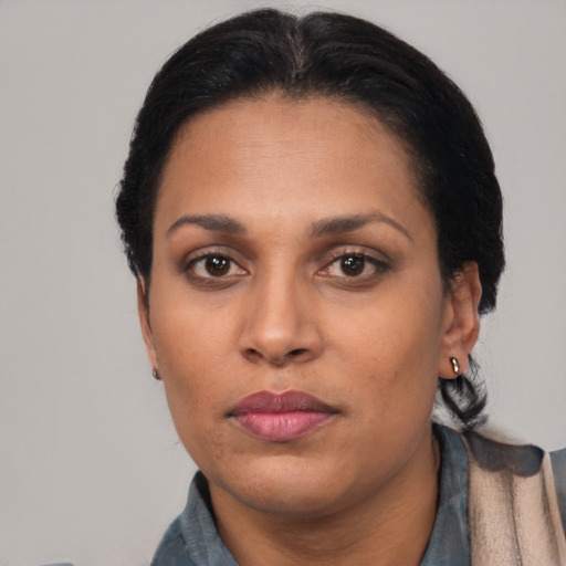 Neutral latino adult female with short  black hair and brown eyes
