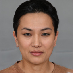 Joyful asian young-adult female with short  black hair and brown eyes