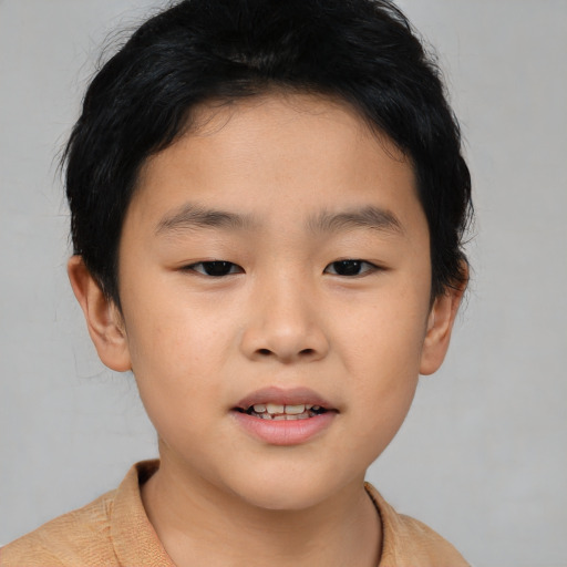 Joyful asian child male with short  brown hair and brown eyes