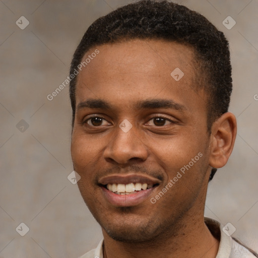 Joyful black young-adult male with short  brown hair and brown eyes