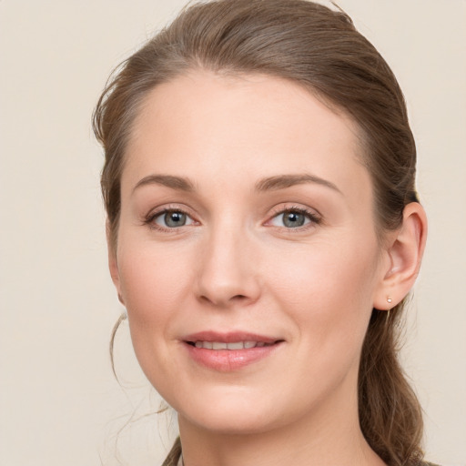 Joyful white young-adult female with medium  brown hair and grey eyes