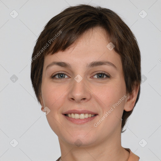 Joyful white young-adult female with short  brown hair and grey eyes