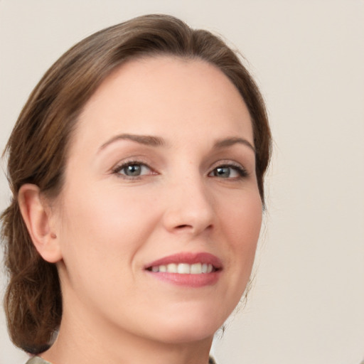 Joyful white young-adult female with medium  brown hair and green eyes