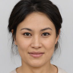 Joyful asian young-adult female with medium  brown hair and brown eyes