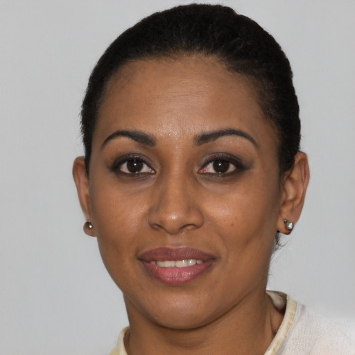 Joyful black young-adult female with short  brown hair and brown eyes