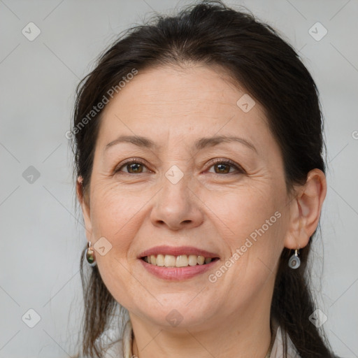 Joyful white adult female with medium  brown hair and brown eyes