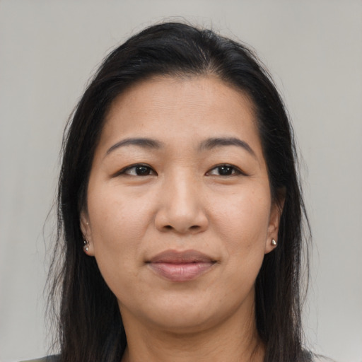 Joyful asian young-adult female with long  brown hair and brown eyes