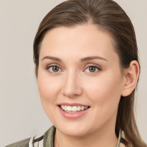 Joyful white young-adult female with medium  brown hair and grey eyes