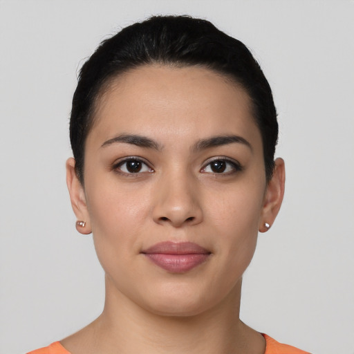 Joyful latino young-adult female with short  black hair and brown eyes