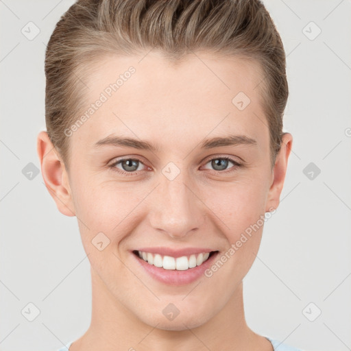 Joyful white young-adult female with short  brown hair and grey eyes