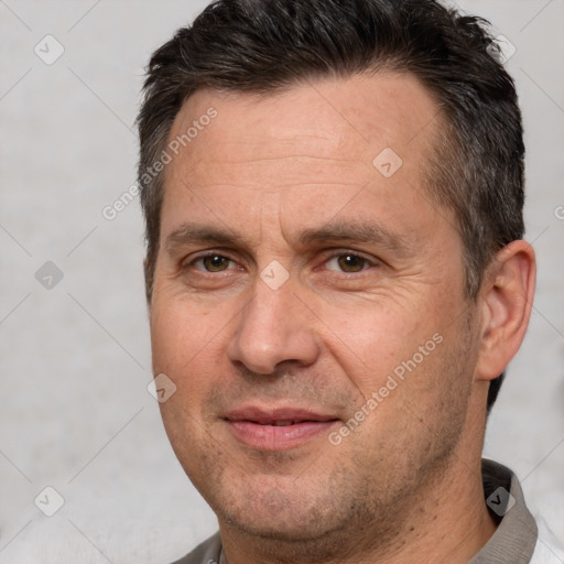 Joyful white adult male with short  brown hair and brown eyes