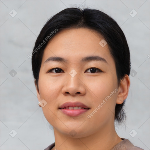 Joyful asian young-adult female with short  black hair and brown eyes