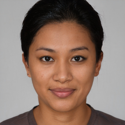 Joyful latino young-adult female with short  brown hair and brown eyes