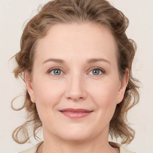 Joyful white young-adult female with medium  brown hair and blue eyes