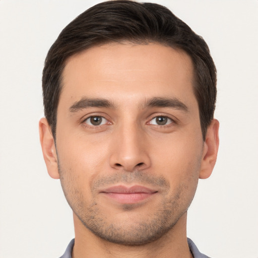 Joyful white young-adult male with short  brown hair and brown eyes