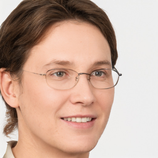 Joyful white adult female with medium  brown hair and green eyes