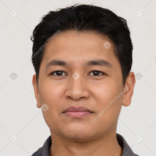 Joyful asian young-adult male with short  black hair and brown eyes