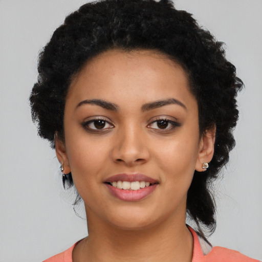 Joyful latino young-adult female with long  black hair and brown eyes