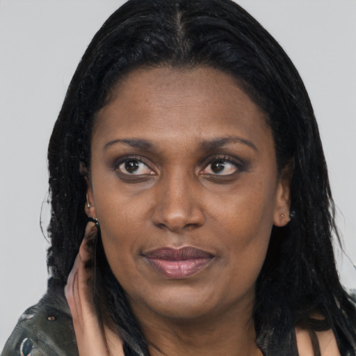 Joyful latino adult female with long  black hair and brown eyes