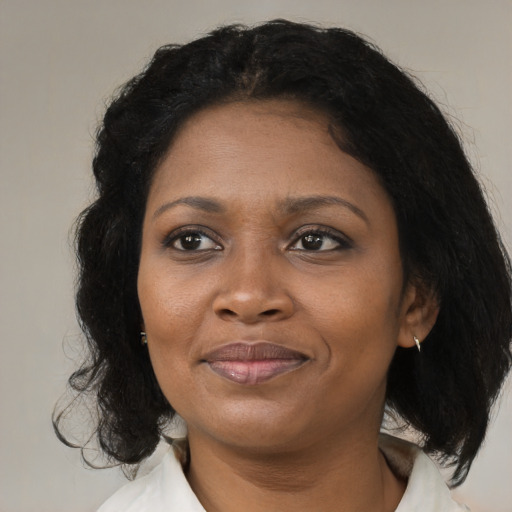 Joyful black adult female with medium  black hair and brown eyes