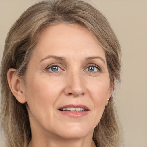 Joyful white adult female with long  brown hair and grey eyes