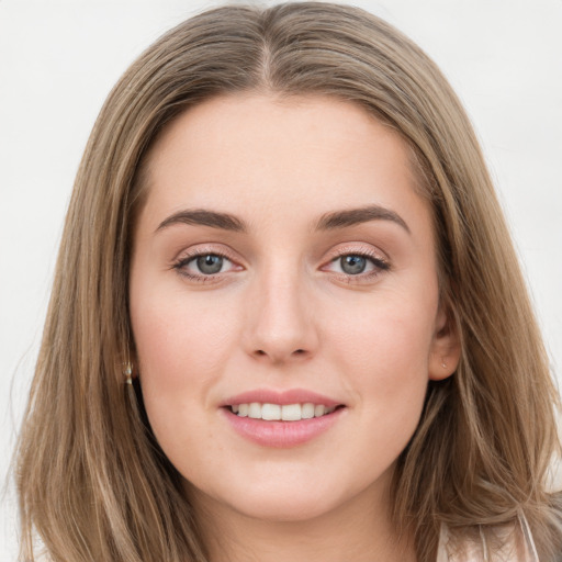 Joyful white young-adult female with long  brown hair and grey eyes