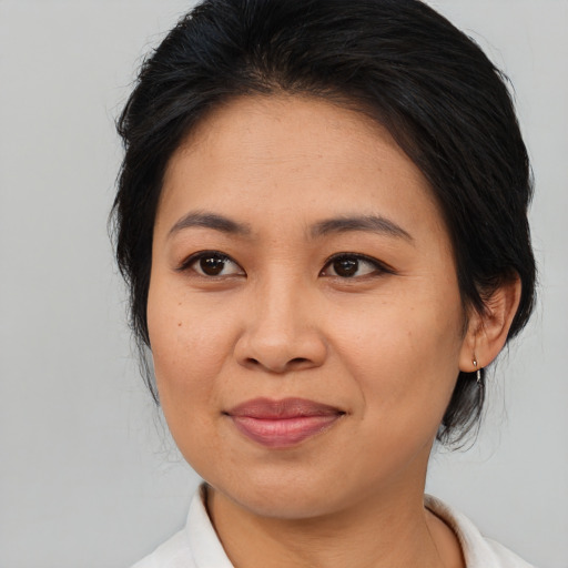 Joyful asian adult female with medium  brown hair and brown eyes