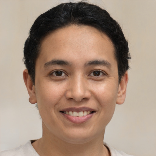Joyful latino young-adult male with short  brown hair and brown eyes